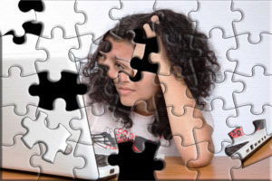 Puzzle image of person at laptop